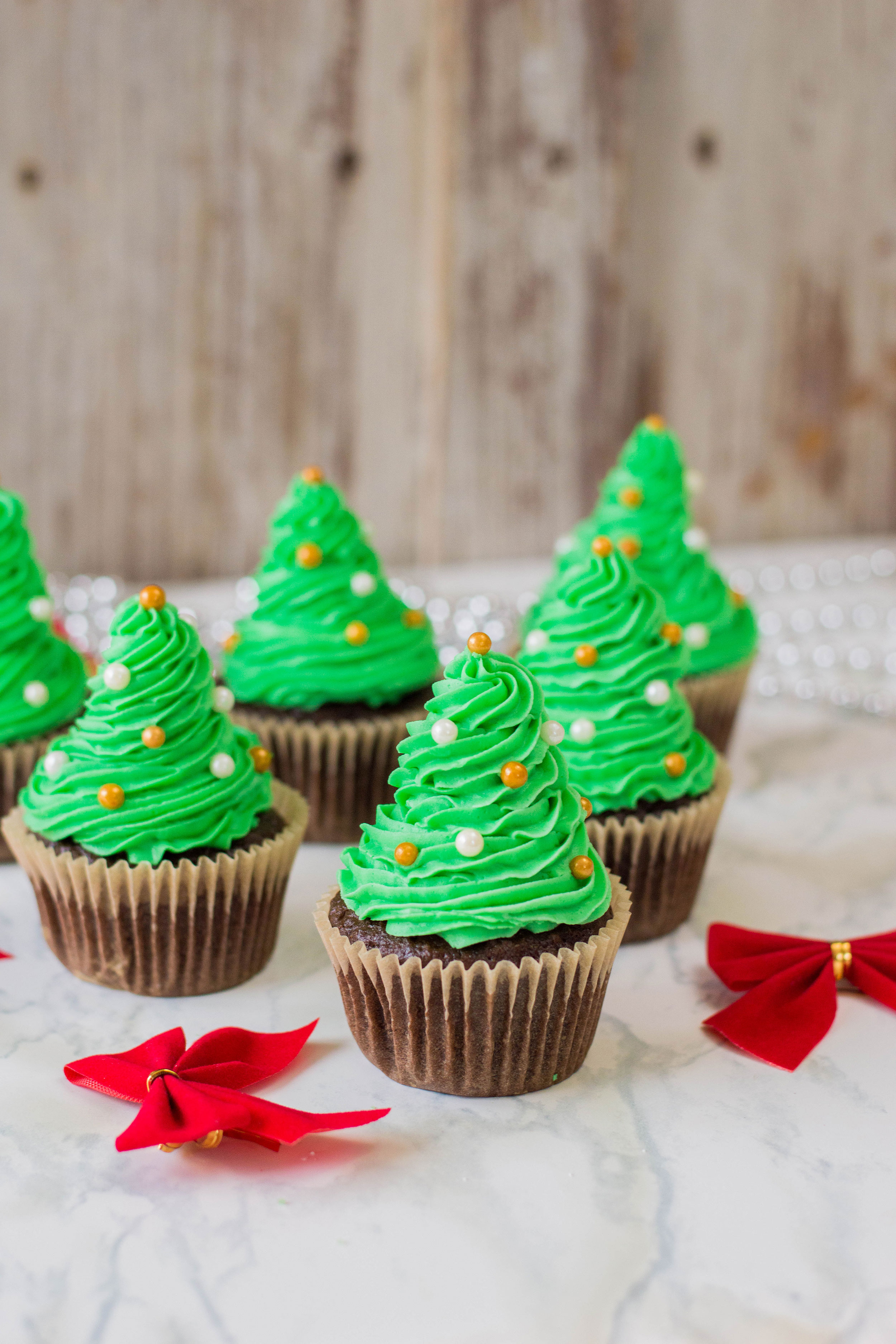 It's the time of the year to get festive with our desserts! These easy Christmas Tree Cupcakes is generously topped with homemade buttercream. Your sweet tooth will thank you later! #christmasdessert