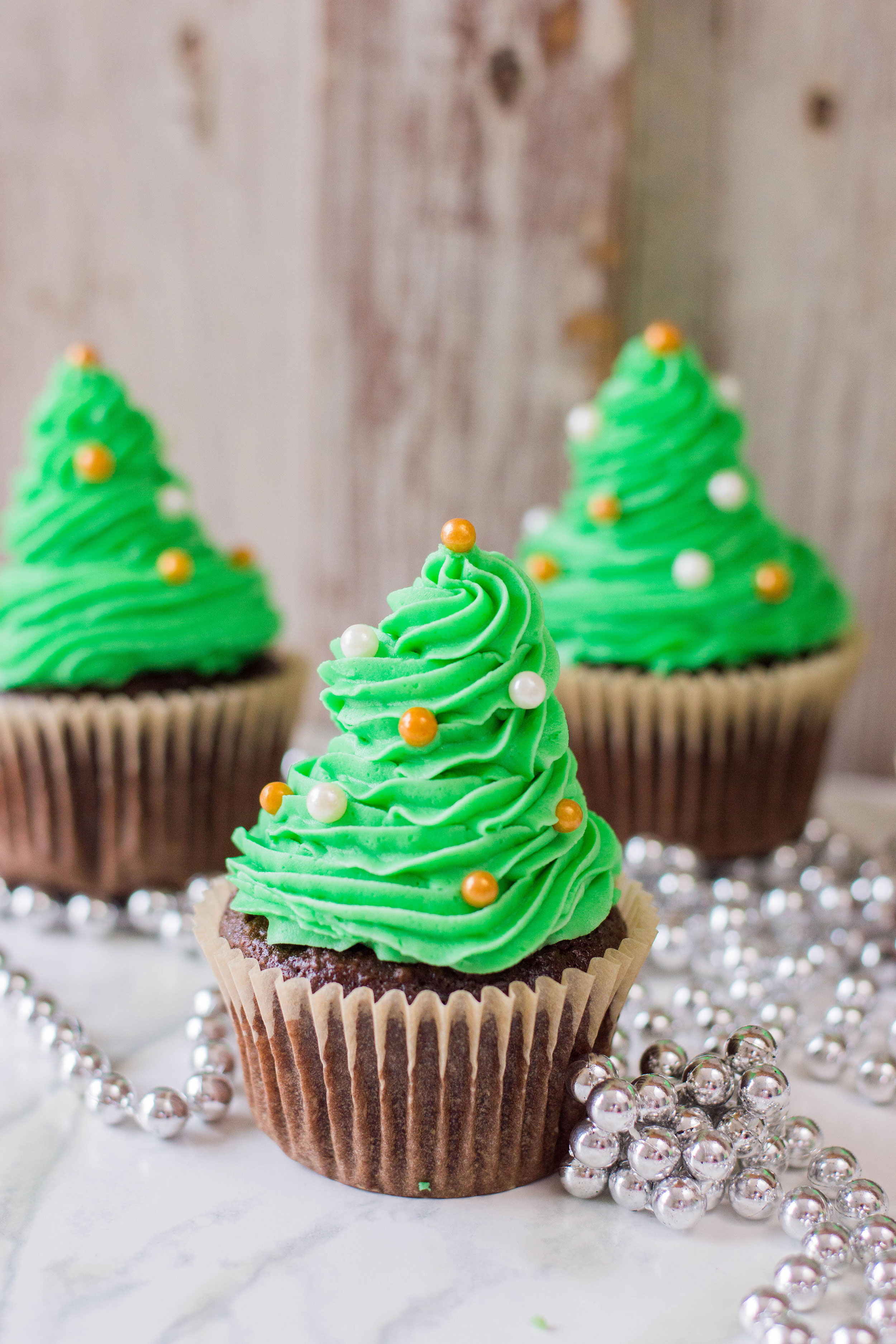 It's the time of the year to get festive with our desserts! These easy Christmas Tree Cupcakes is generously topped with homemade buttercream. Your sweet tooth will thank you later! #christmasdessert